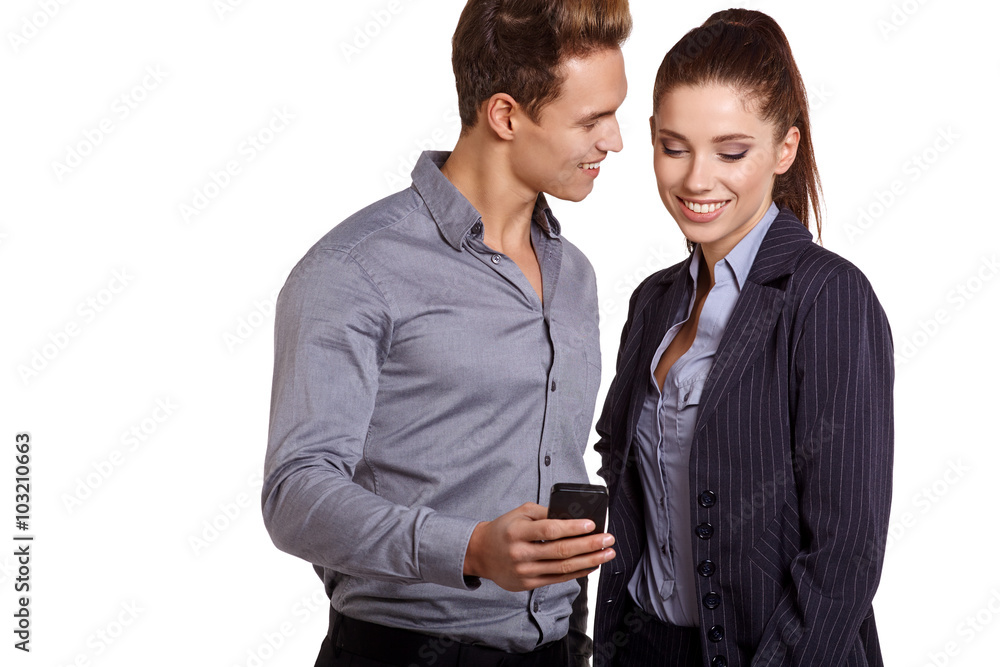 Smiling couple on phone call looking at each other on white screen Smiling couple on phone call looking at each other on white screen