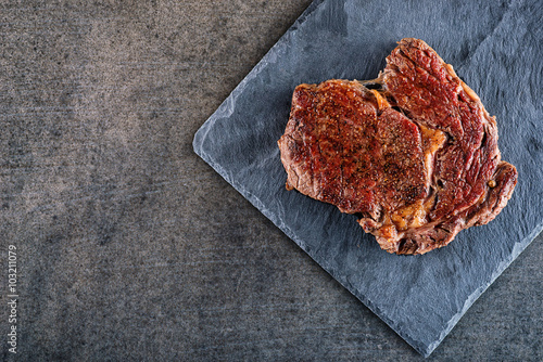 grilled beef steak fillet on black board, food background for restaurant, place for text