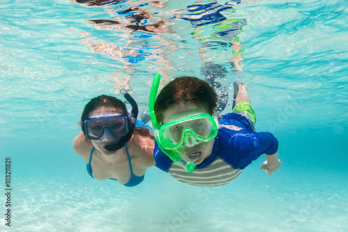 Family snorkeling in tropical water