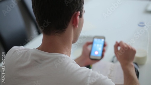 Man dials number on mobile phone and calls.