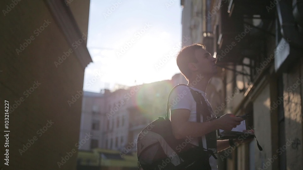 Man dials and bustles between buildings. Man dials and bustles between buildings.