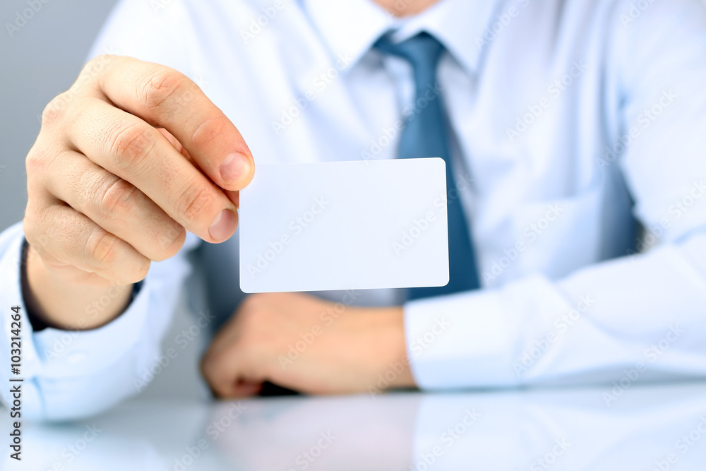 Closeup portrait of businessman giving a business card Closeup portrait of businessman giving a business card