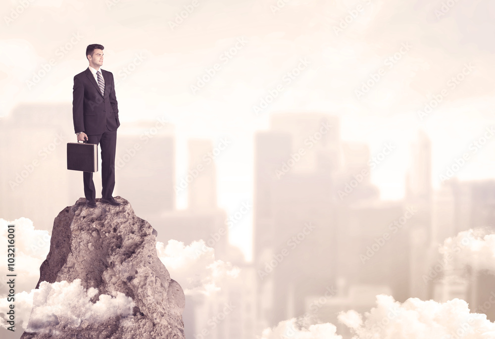 Confident businessman on dangerous cliff Confident businessman on dangerous cliff