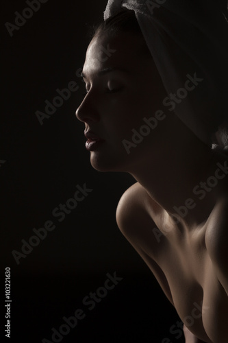 Silhouette profile of a beautiful young woman with a towel on her head