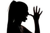 silhouette profile of a woman who is mocking with the palm of on the nose