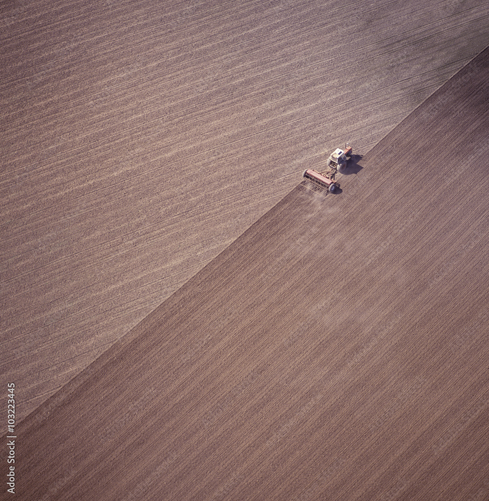 Aerial view of tractor ploughing a paddock in the far west of NSW getting ready for a wheat crop.
