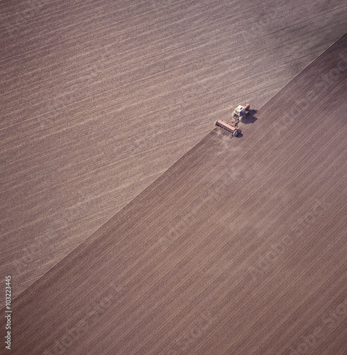 Aerial view of tractor ploughing a paddock in the far west of NSW getting ready for a wheat crop.