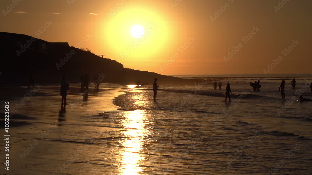 People playing on beach in shallow water in silhouette,Cape Town,South Africa