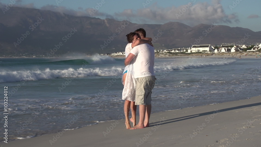 Man and woman enjoying romantic embrace on the beach, Cape Town,South Africa