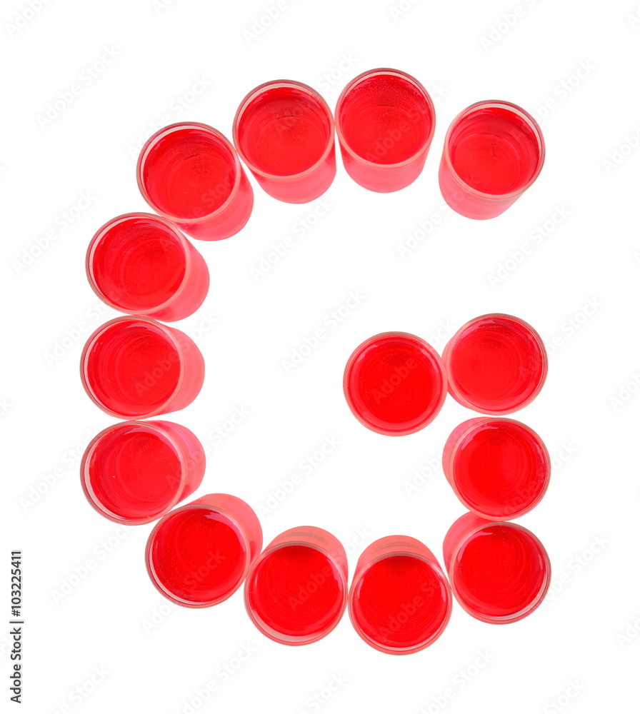 One letter of the alphabet. red drink in a glass One letter of the alphabet. red drink in a glass