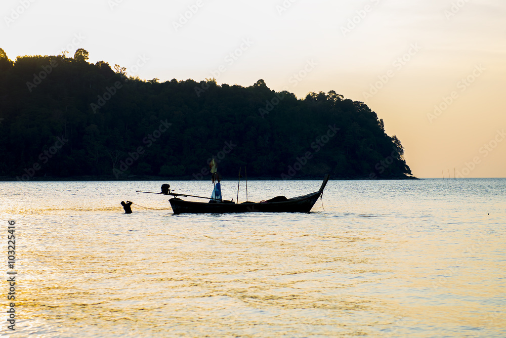 Silhouette fishing boat on the sea in summer