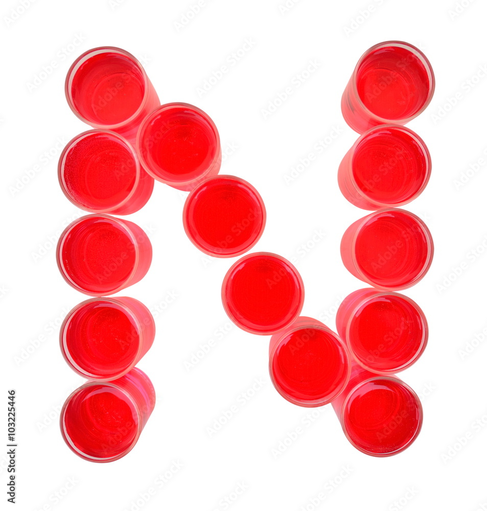 One letter of the alphabet. red drink in a glass One letter of the alphabet. red drink in a glass