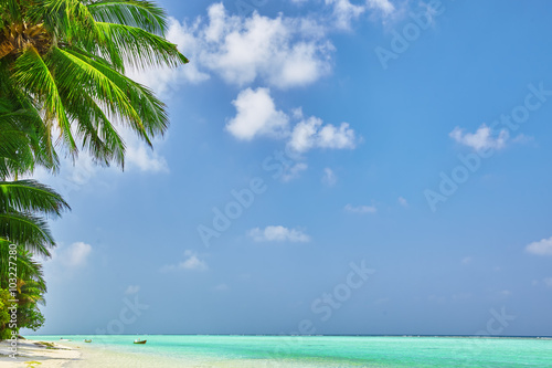 Shoreline of a tropical island in the Maldives and view of the I