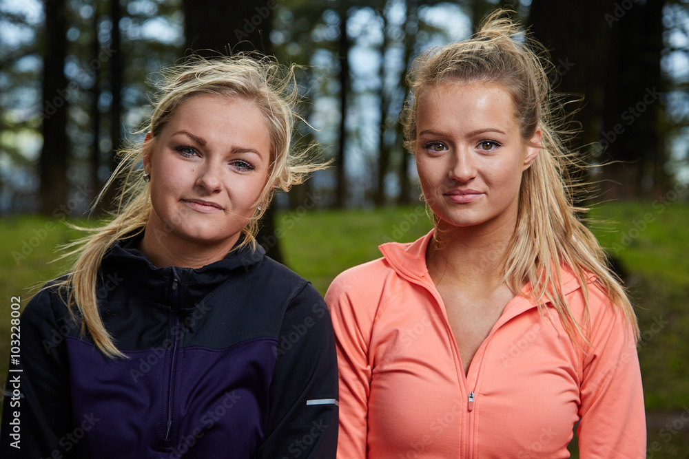 Running Women Standing Side by Side in Forest Looking at camera