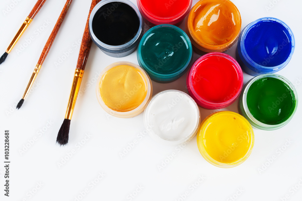 Jars with colored gouache and paint brushes. Jars with colored gouache and paint brushes.