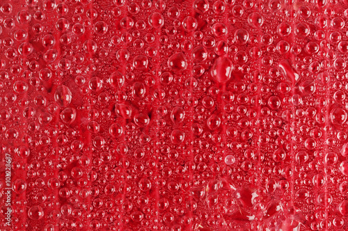 Water drops on red glass