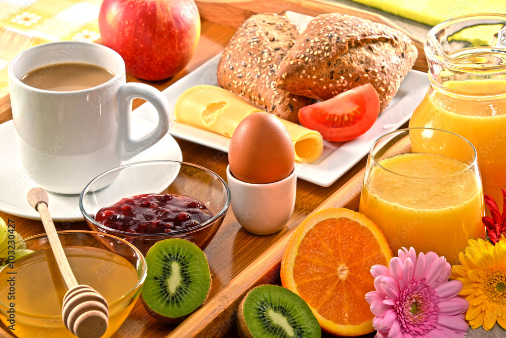 Breakfast on tray served with coffee, juice, egg, and rolls Breakfast on tray served with coffee, juice, egg, and rolls