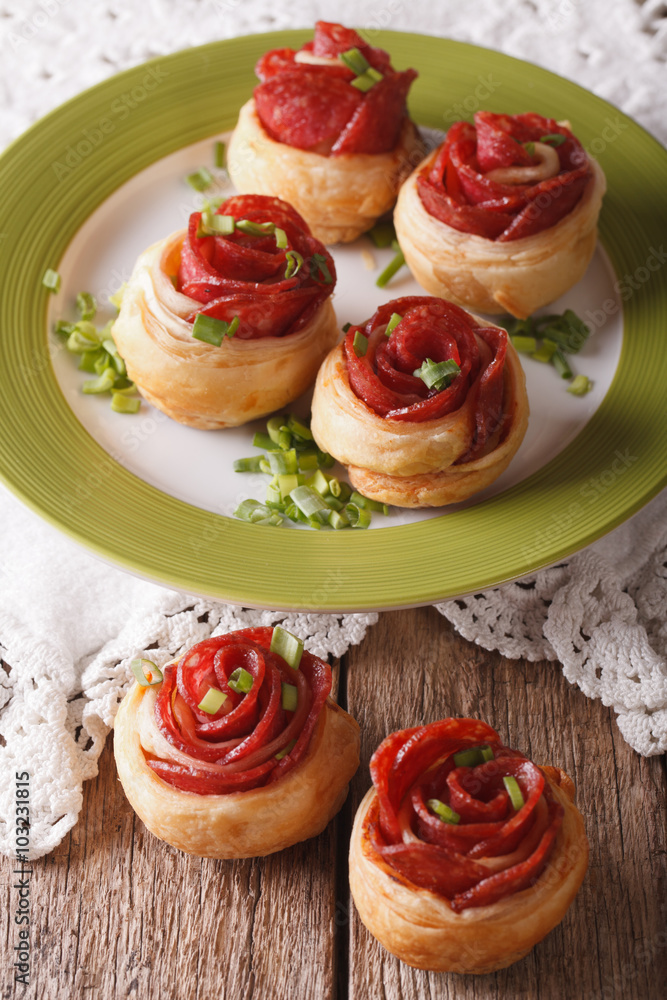 Baked rolls with salami in the form of roses closeup. vertical
Baked rolls with salami in the form of roses closeup. vertical