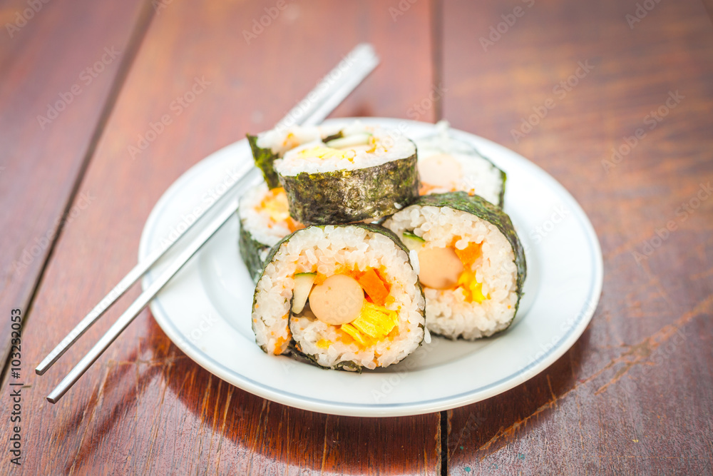Close up of Rolled sushi rice on a white dish , Dark Vintage color filter Close up of Rolled sushi rice on a white dish , Dark Vintage color filter