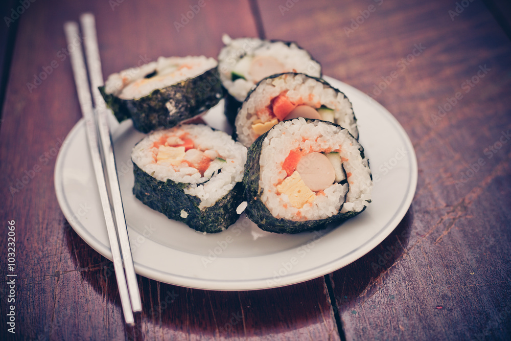 Close up of Rolled sushi rice on a white dish , Dark Vintage color filter Close up of Rolled sushi rice on a white dish , Dark Vintage color filter