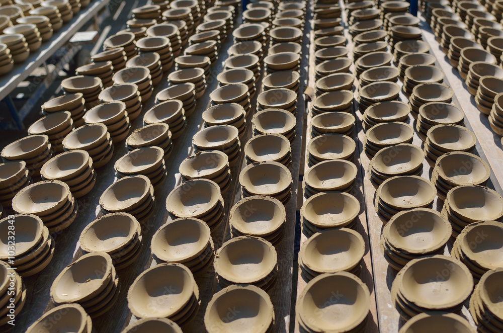 Obraz premium Ceramic cup in rack prepare for bring in furnace in factory