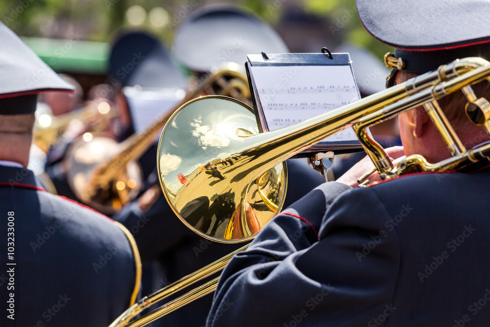 Fototapeta premium musician of the military orchestra playing on gold trombone