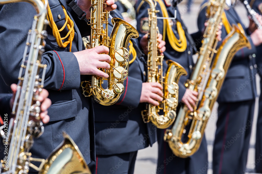Fototapeta premium musicians of army orchestra plays his gold saxophones
