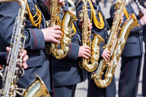 musicians of army orchestra plays his gold saxophones