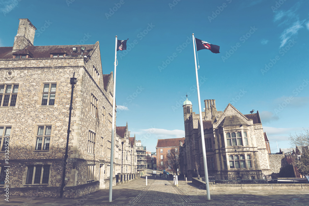 Fluttering flags in front of British buildings