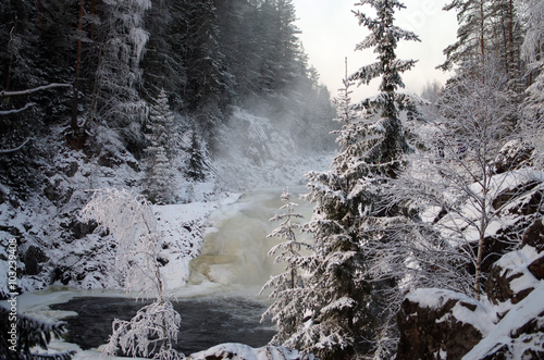 Frozen waterfall Kivach in  cloudy January day. Karelia, Russia photo