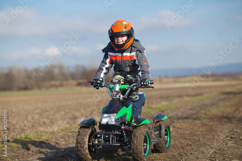 Boy rides on electric ATV quad.