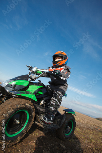 Boy rides on electric ATV quad.