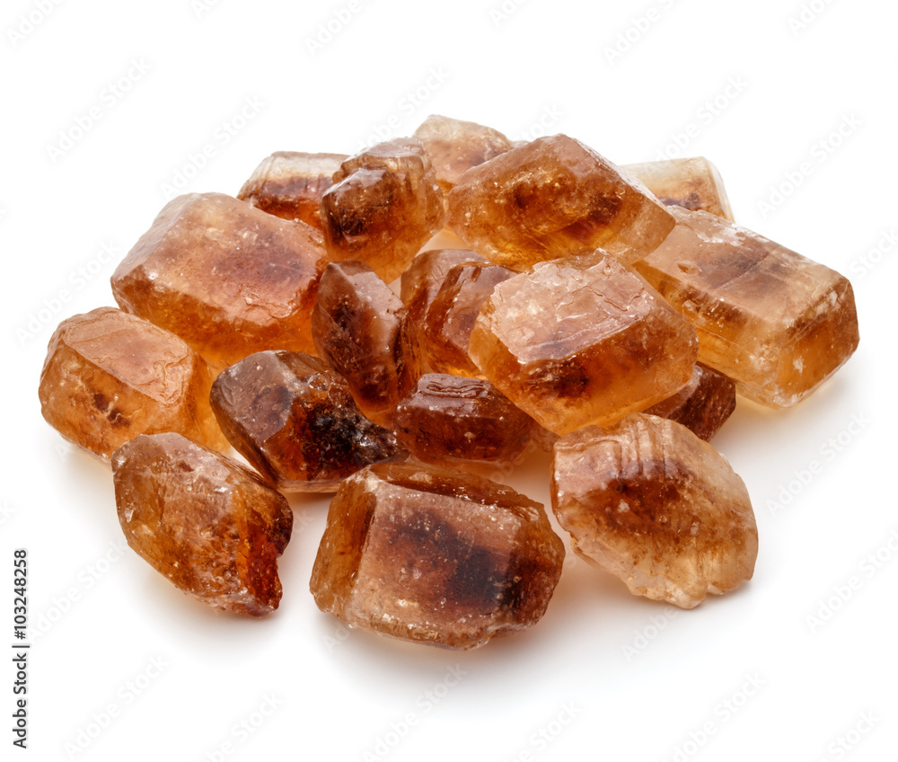 Brown caramelized lump cane sugar cube isolated on white backgro Brown caramelized lump cane sugar cube isolated on white backgro