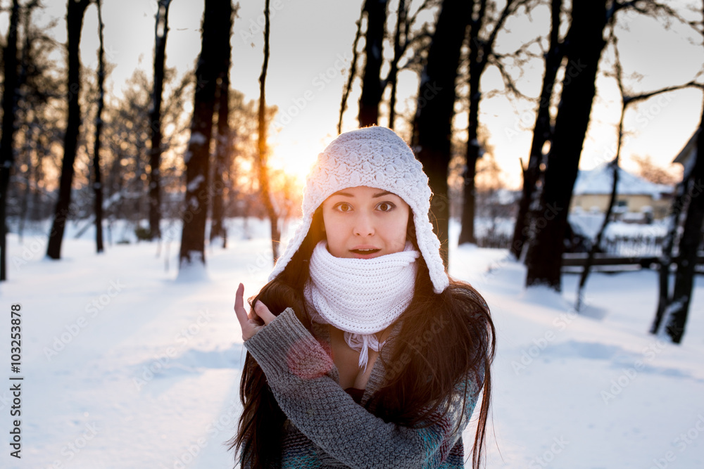 Obraz premium attractive young woman (Girl) playing with snow in warm clothing smiling in the Park