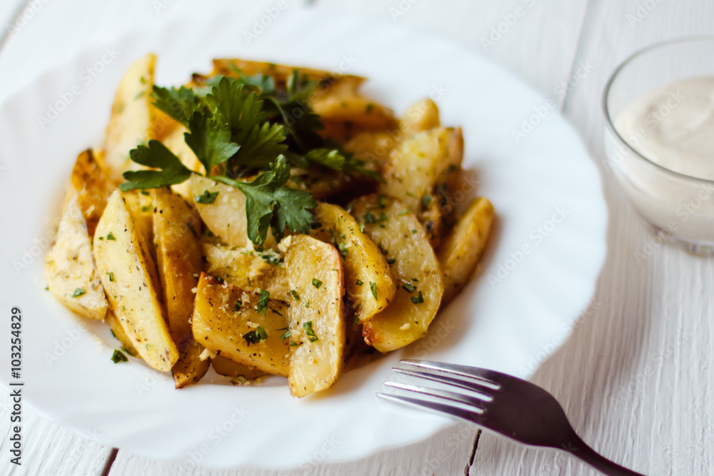 beautiful roasted potatoes with herbs and spices on a white plate beautiful roasted potatoes with herbs and spices on a white plate