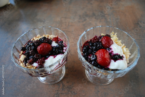 Two berries  strawberries  blueberries  blackberries  desserts with yogurt and rice flakes in glass cup. Fresh dessert.