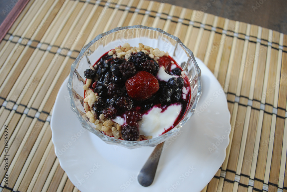 Berries (strawberries, blueberries, blackberries) dessert with yogurt and rice flakes in glass cup. Finished dish. Berries (strawberries, blueberries, blackberries) dessert with yogurt and rice flakes in glass cup. Finished dish.