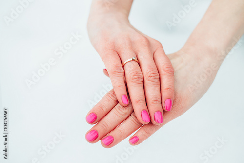 girl s hand with ring on a simple background