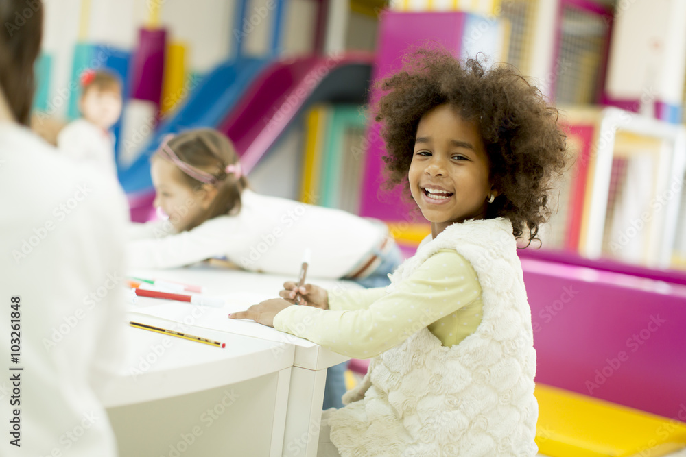 Multiracial children drawing in the playroom