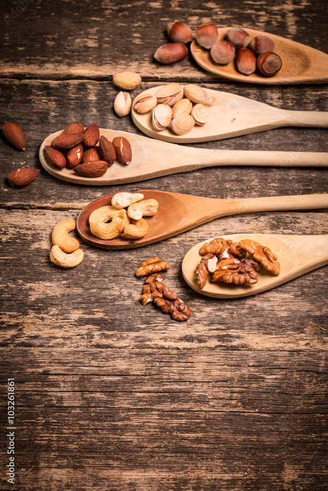Mix nuts on wooden table,healthy vegan food. Mix nuts on wooden table,healthy vegan food.