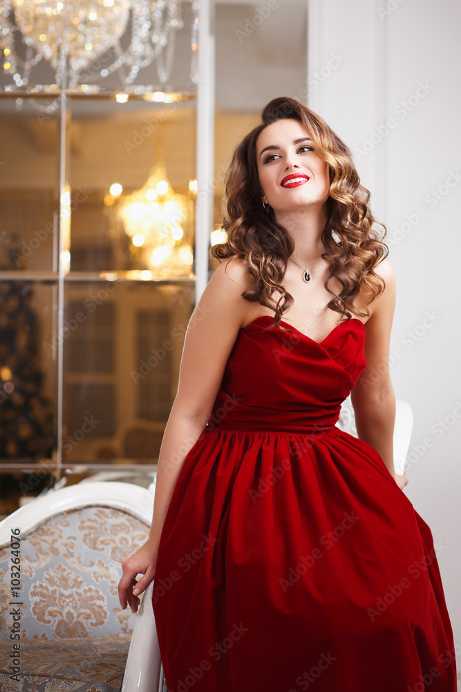 Beautiful young woman with perfect make up and hair style in gorgeous red evening  dress in expensive luxury interior Stock Photo | Adobe Stock