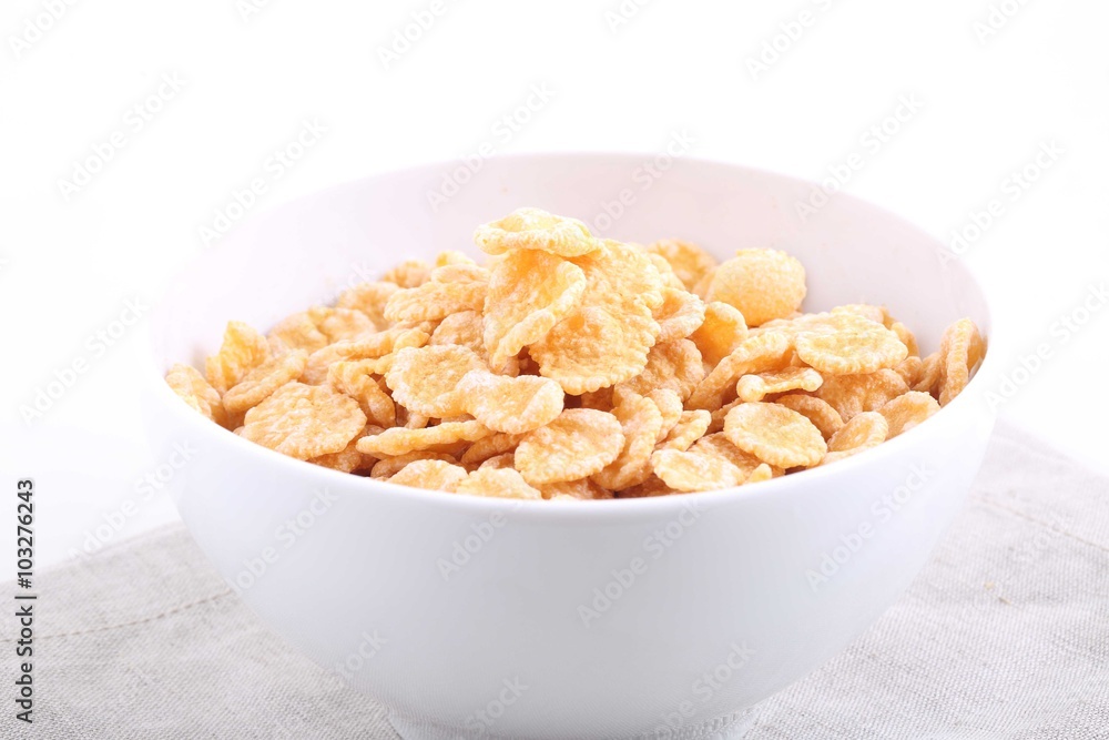 Corn and rice flakes in a cup on a white background Corn and rice flakes in a cup on a white background