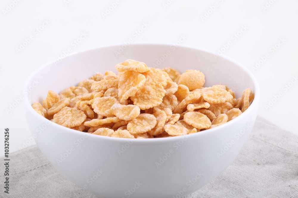 Corn and rice flakes in a white cup, a breakfast Corn and rice flakes in a white cup, a breakfast