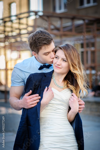 bride and groom are walking in city on wedding day