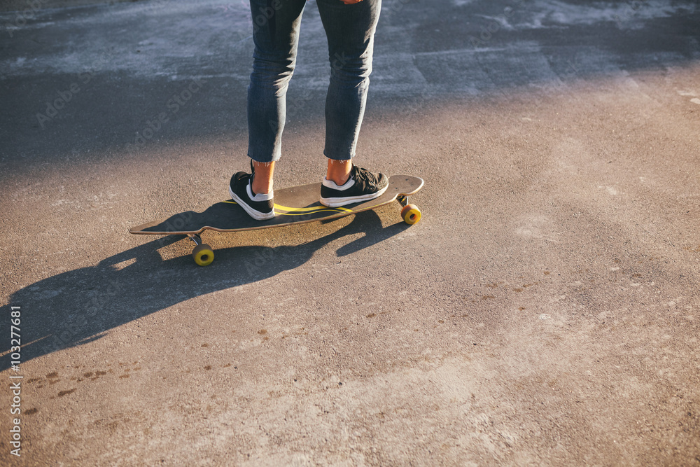 Image of a man with longboard going on road Image of a man with longboard going on road