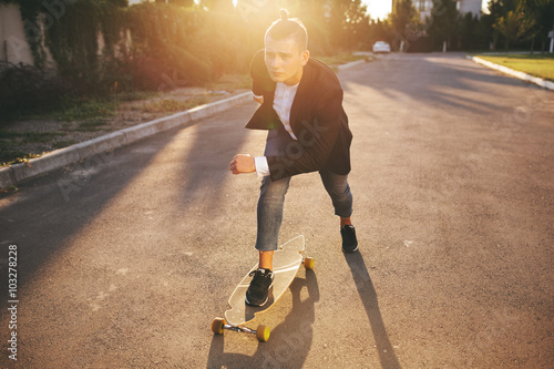 Image of a man with longboard going on road photo