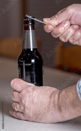 Beer bottle being opened by a man