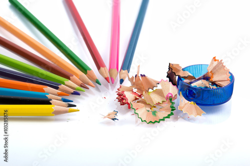 colored pencils and pencil sharpener on a white background