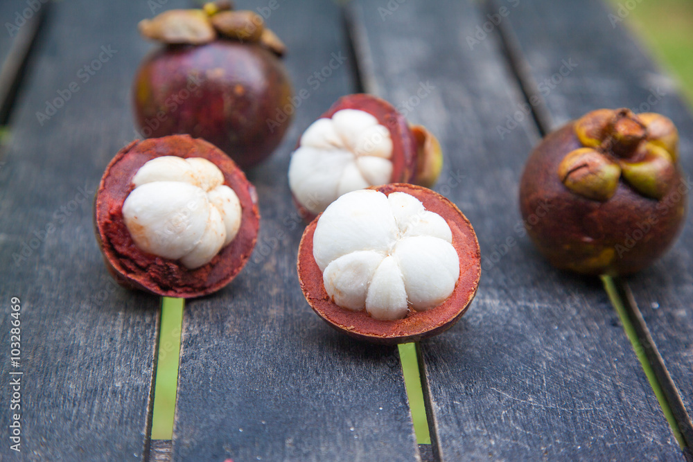 mangosteens on a wooden table mangosteens on a wooden table