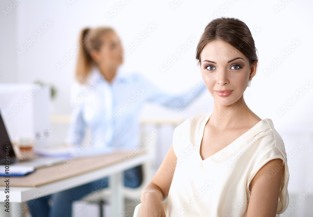 Portrait of a businesswoman sitting at desk with laptop Portrait of a businesswoman sitting at desk with laptop